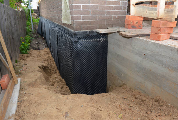 Happy homeowners after waterproofing job in Corinth